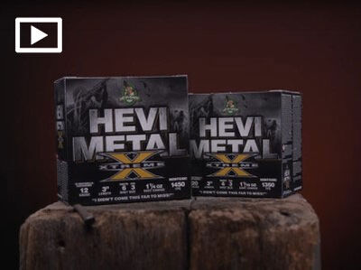 two HEVI-Metal Xtreme boxes sitting on a log with a play button in the left corner