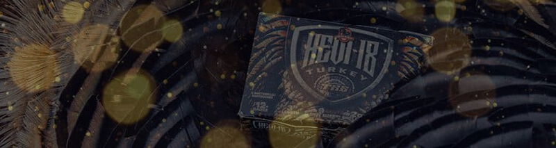 2 hunters crouching next to corn field